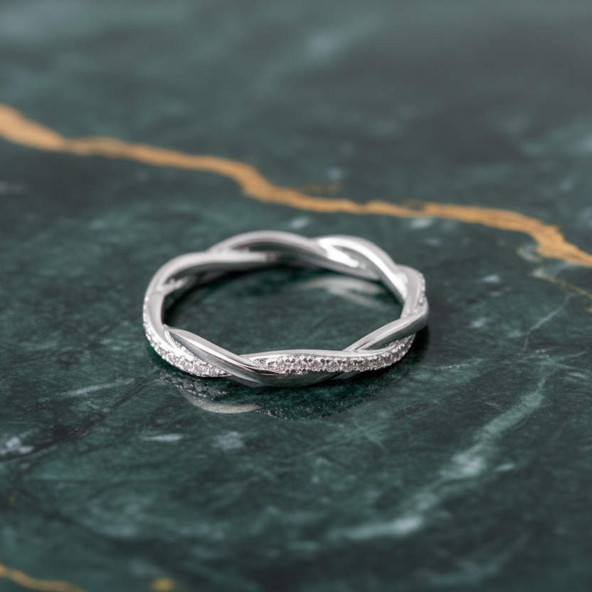 Silver ring on a dark green marble surface