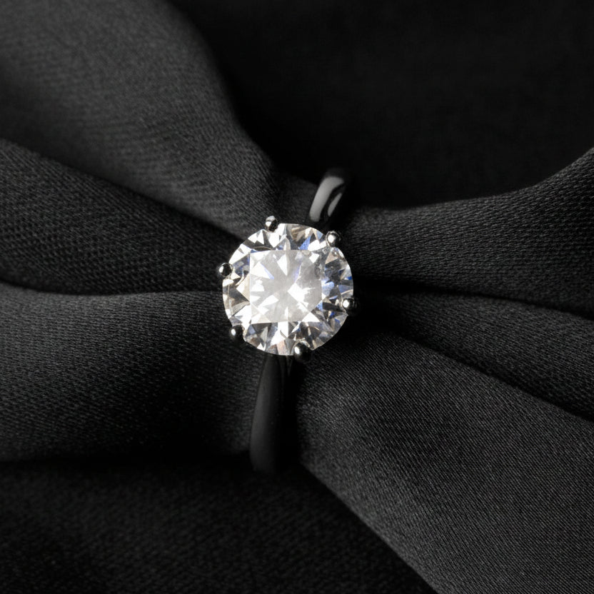 Moissanite ring on a black fabric background