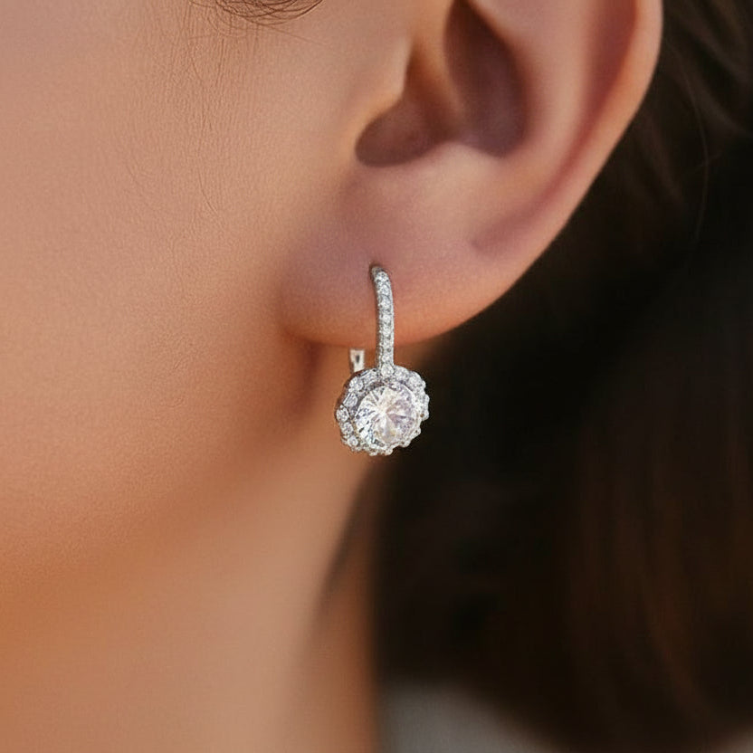 Close-up of Versailles Halo Moissanite Earrings on a model, highlighting the elegant drop and secure leverback positioning