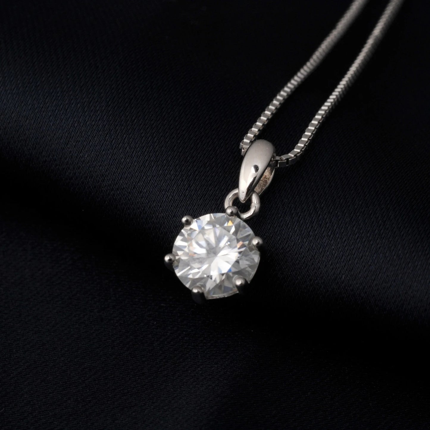 Moissanite pendant on a black background