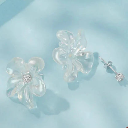 Pair of small silver stud earrings featuring a simple, elegant floral design