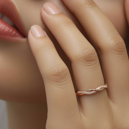 Close-up of a hand wearing a rose gold ring with a blurred background