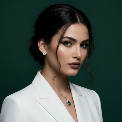 Woman wearing a white blazer with jewelry on a dark green background